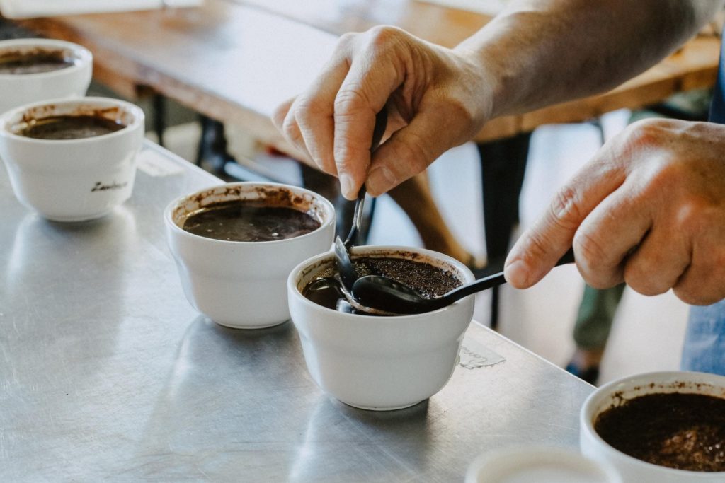 café préparé dans des bols de dégustation avec du café en grains à côté.